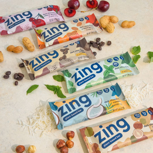 six different zing plant-based bars with their raw ingredients