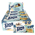 A box of Zing Energy Bar snack sticks with two individual bars displayed in front on a plain white background. The packaging features light blue, white, and yellow graphics with coconut illustrations and text indicating dark chocolate coconut flavor and prebiotics.
