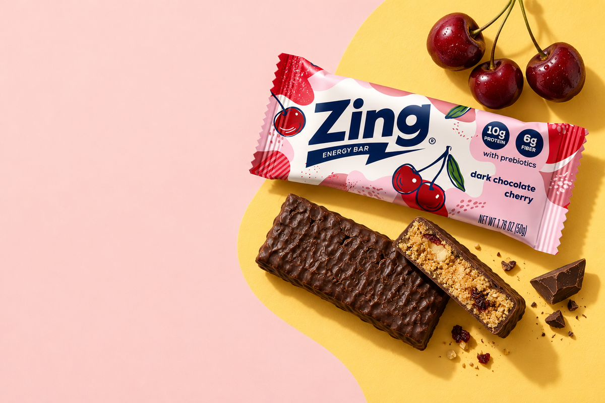 zing dark chocolate cherry bar laying on table next to a broken bar.
